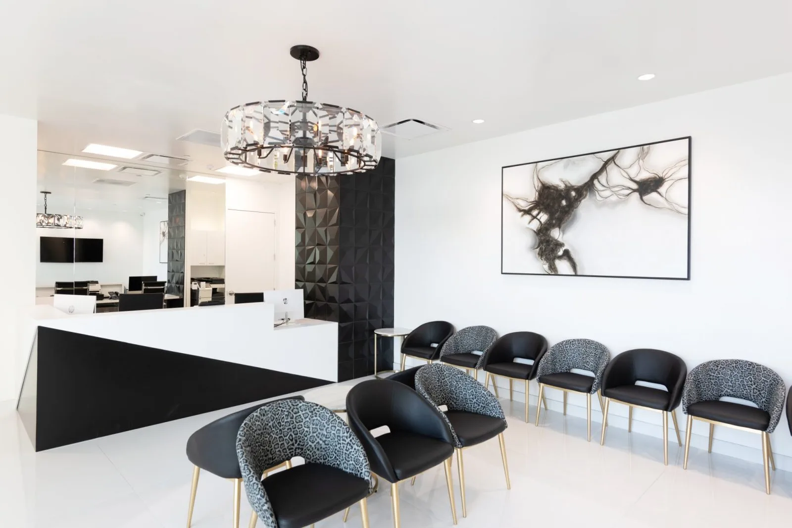 Modern dermatology clinic waiting room with white reception desk, patterned chairs, and contemporary artwork